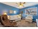 Living room featuring blue walls, a ceiling fan, sofa and two sitting chairs at 13633 N 111Th Ave, Sun City, AZ 85351