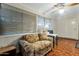 Bright sun room with a ceiling fan, a sofa, and windows, providing a comfortable and relaxing space at 13633 N 111Th Ave, Sun City, AZ 85351