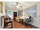 Cozy sun room with a ceiling fan, a sofa, a bookcase, a desk, and access to other rooms at 13633 N 111Th Ave, Sun City, AZ 85351