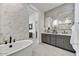 Bright bathroom boasts a soaking tub and dual sink vanity with contemporary finishes at 14543 N Adero Canyon Dr, Fountain Hills, AZ 85268