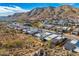 Elevated view of a desert community showcases modern houses against a backdrop of mountains under a clear, blue sky at 14543 N Adero Canyon Dr, Fountain Hills, AZ 85268