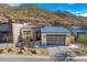 Beautiful single story home with modern garage door, desert landscaping, and mountain views at 14543 N Adero Canyon Dr, Fountain Hills, AZ 85268