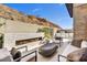 Comfortable seating area with a stone fireplace and outdoor kitchen for delightful open-air gatherings at 14543 N Adero Canyon Dr, Fountain Hills, AZ 85268