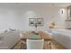 Dining room with a wooden table and white chairs next to an open, bright living area at 15215 N Kierland Blvd # 106, Scottsdale, AZ 85254