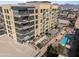 High-rise apartment building featuring a sparkling pool, lush greenery, and modern architecture at 15215 N Kierland Blvd # 106, Scottsdale, AZ 85254