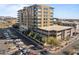 Exterior view of a modern apartment building with balconies, parking, and landscaping at 15215 N Kierland Blvd # 106, Scottsdale, AZ 85254