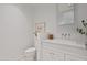 Stylish powder room showcasing a modern vanity with white marble countertop and brushed metal hardware at 15215 N Kierland Blvd # 106, Scottsdale, AZ 85254