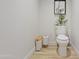 Toilet and basket in a half bath at 15215 N Kierland Blvd # 106, Scottsdale, AZ 85254