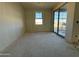 Bright bedroom with lots of light from large window and sliding glass door to back at 15752 W Beryl Ave, Waddell, AZ 85355