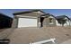 Attractive single-story home featuring a brick driveway and a white garage door at 15752 W Beryl Ave, Waddell, AZ 85355