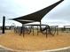 Engaging playground area equipped with climbing nets, slides, and play structures, offering a dynamic space for children at 15752 W Beryl Ave, Waddell, AZ 85355