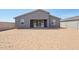 Large backyard with sliding glass door to patio offers an opportunity to create a custom outdoor living space at 15762 W Cheryl Dr, Waddell, AZ 85355