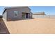 Unfinished backyard features a covered patio and block wall fence, perfect for creating a private oasis at 15762 W Cheryl Dr, Waddell, AZ 85355