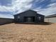 Spacious backyard with minimal landscaping and privacy wall in the background at 15762 W Cheryl Dr, Waddell, AZ 85355