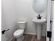 Powder bathroom with pedestal sink and toilet at 15762 W Cheryl Dr, Waddell, AZ 85355