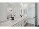 Bathroom features a long double sink vanity with black hardware at 15762 W Cheryl Dr, Waddell, AZ 85355