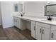 Bathroom features dual sinks, white cabinetry, and black hardware at 15762 W Cheryl Dr, Waddell, AZ 85355