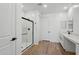 This bathroom boasts a glass-enclosed shower, white vanity, and wood-look tile flooring at 15762 W Cheryl Dr, Waddell, AZ 85355