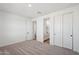 Bright bedroom boasts neutral carpet, ensuite bathroom, and convenient closet space at 15762 W Cheryl Dr, Waddell, AZ 85355