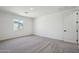This bedroom provides a relaxing space with carpeted floors, a window, and a door at 15762 W Cheryl Dr, Waddell, AZ 85355