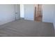 Spacious bedroom with neutral carpet and ample natural light at 15762 W Cheryl Dr, Waddell, AZ 85355