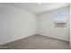 Bedroom showcasing neutral carpet, a window, and white walls at 15762 W Cheryl Dr, Waddell, AZ 85355