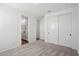 Bright bedroom boasts neutral carpet, ensuite bathroom, and convenient closet space at 15762 W Cheryl Dr, Waddell, AZ 85355