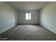 Neutral bedroom with carpet flooring and a window offering natural light at 15762 W Cheryl Dr, Waddell, AZ 85355