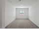 Bedroom showcasing neutral carpet, a window, and white walls at 15762 W Cheryl Dr, Waddell, AZ 85355