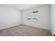 Bright, empty bedroom with neutral carpet and a window to let in plenty of natural light at 15762 W Cheryl Dr, Waddell, AZ 85355