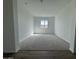 Bonus room with neutral carpet, white walls, and a window providing plenty of natural light at 15762 W Cheryl Dr, Waddell, AZ 85355