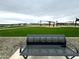 A metal bench overlooking the community park, a playground, and picnic areas at 15762 W Cheryl Dr, Waddell, AZ 85355