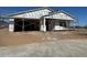 New home in construction phase showing the framing of the house with a two-car garage and covered entry at 15762 W Cheryl Dr, Waddell, AZ 85355