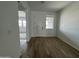 Entryway with wood-look tile flooring, white door, and natural light at 15762 W Cheryl Dr, Waddell, AZ 85355