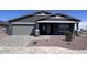 Charming single-story home with a two-car garage, desert landscaping, and a welcoming front porch at 15762 W Cheryl Dr, Waddell, AZ 85355
