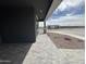 View of a covered front porch with stone accents, pavers, and a view of the community park at 15762 W Cheryl Dr, Waddell, AZ 85355