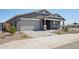Inviting single-level home with a gray exterior and a two-car garage, set on a landscaped lot at 15762 W Cheryl Dr, Waddell, AZ 85355