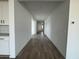 Long hallway featuring wood-look tile flooring and bright white walls at 15762 W Cheryl Dr, Waddell, AZ 85355