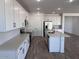 Modern kitchen with white cabinets, stainless steel appliances, and center island at 15762 W Cheryl Dr, Waddell, AZ 85355