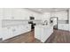 Modern kitchen with white cabinets, stainless steel appliances, quartz countertops, and tile backsplash at 15762 W Cheryl Dr, Waddell, AZ 85355