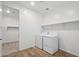 Laundry room featuring a washer, dryer, and shelving at 15762 W Cheryl Dr, Waddell, AZ 85355