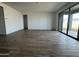 Bright living room features wood-look tile flooring and sliding glass doors at 15762 W Cheryl Dr, Waddell, AZ 85355