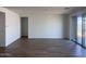 Open living room with tile flooring, sliding glass doors, and ample space for entertaining at 15762 W Cheryl Dr, Waddell, AZ 85355