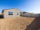 The new construction home's backyard has been graded and is awaiting landscaping at 15993 W Cottontail Ln, Surprise, AZ 85387