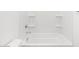 Clean bathtub with shower head and shelving at 15993 W Cottontail Ln, Surprise, AZ 85387