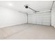 A clean garage has sealed concrete floors and an insulated garage door at 15993 W Cottontail Ln, Surprise, AZ 85387