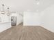 Spacious living room featuring wood-look tile floors, white walls and recessed lighting at 15993 W Cottontail Ln, Surprise, AZ 85387