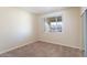 This bedroom features a large sliding window, carpeted floor, and a mirrored sliding closet at 16013 S Desert Foothills Pkwy # 2077, Phoenix, AZ 85048