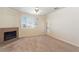 Cozy living room featuring neutral-colored walls, carpet, a tile fireplace, and an entrance to the outside at 16013 S Desert Foothills Pkwy # 2077, Phoenix, AZ 85048