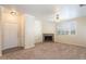 Cozy living room featuring neutral-colored walls, carpet, a tile fireplace, and an entrance to the front door at 16013 S Desert Foothills Pkwy # 2077, Phoenix, AZ 85048